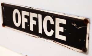 sign spelling office in white letters on black background