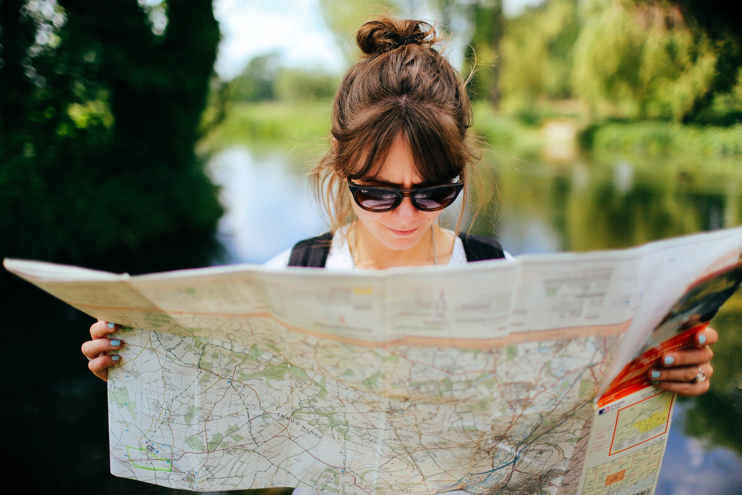 woman reading map. process goals are like a map to our outcome goals.