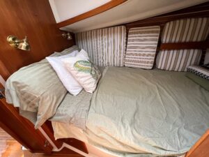 Forward v berth on sailboat with green linen