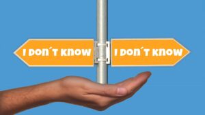 hand with pole balanced on it show signs in opposite directions each saying "I don't know"