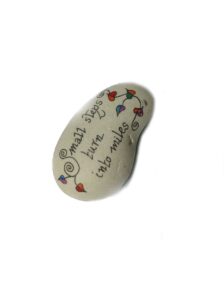 light grey stone with writing - small steps turn into miles and leaf graphic, 