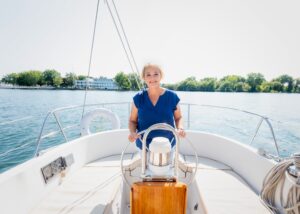 Carolyn Caldwell at the helm of a sailboat